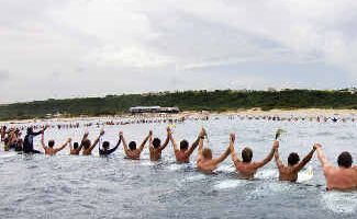 Plenty of tears: Fellow surfers and admirers link hands yesterday at Puerto Rico in memory of Andy Irons. Plenty of tears: Fellow surfers and admirers link hands yesterday at Puerto Rico in memory of Andy Irons.